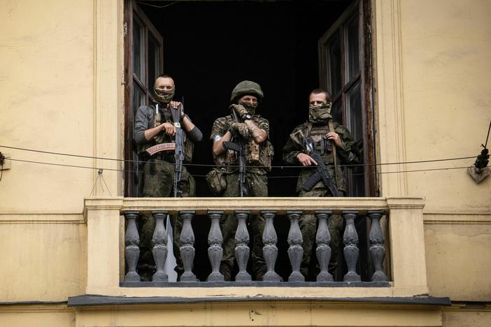 Members of Wagner Group stand on the balcony of a building in the city of Rostov-on-Don on Saturday.