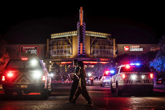 Movie-goers evacuate the Century Rio movie theater as officers respond to a shooting at the theater located at 4901 Pan American freeway in northeast Albuquerque, N.M., on Sunday, June 25, 2023.