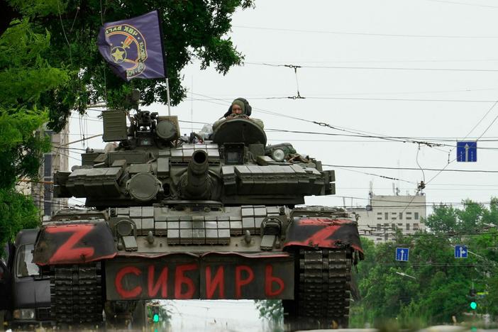 Members of the Wagner Group sit atop of a tank in Rostov-on-Don, Russia, on Saturday. President Vladimir Putin said an armed mutiny by Wagner mercenaries was a "stab in the back" and that the group's chief, Yevgeny Prigozhin, had betrayed Russia. Prigozhin later called off his group's action and the Kremlin said he would go to Belarus.