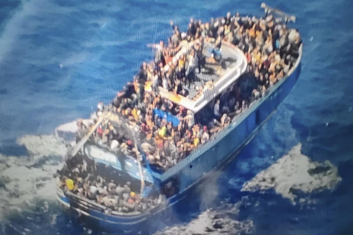 This handout image provided by Greece's coast guard on June 14 shows scores of people on a battered fishing boat that later capsized and sank off southern Greece, drowning hundreds of migrants.