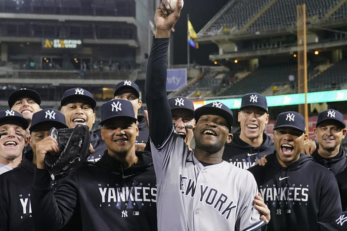 New York Yankees pitcher Domingo Germán, center, poses for a photograph with the team after his perfect game against the Oakland Athletics during a baseball game in Oakland, Calif., Wednesday, June 28, 2023.