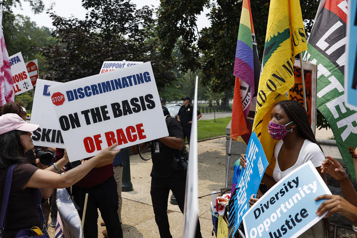 Protesters for and against affirmative action demonstrate on Capitol Hill on Thursday. The Supreme Court ruled that race-conscious admissions programs at Harvard University and the University of North Carolina are unconstitutional.