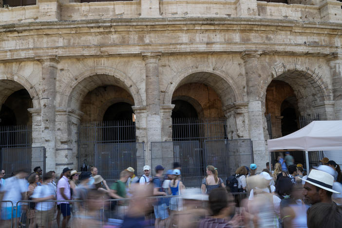 Visitors stand in a line to enter the ancient Colosseum, in Rome, Tuesday, June 27, 2023. Italian police on Thursday, June 29, 2023, said they believe the person who was filmed while engraving his name on the ancient Roman Colosseum is a tourist who lives in Britain. Italian law enforcement said in a release that the identification was made using photographic comparisons.