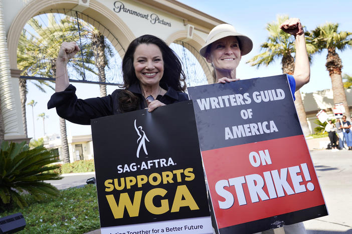 Fran Drescher (left), president of SAG-AFTRA, and Meredith Stiehm, president of Writers Guild of America West, pose together during a rally by striking writers outside Paramount Pictures studio in Los Angeles on May 8.