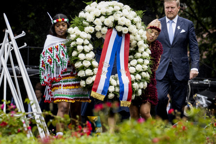 Dutch King Willem-Alexander lays a wreath at the slavery monument Saturday after apologizing for the royal house's role in slavery in a speech greeted by cheers and whoop.