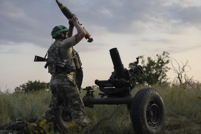 A Ukrainian serviceman of the 3rd Assault Brigade prepares to fire a mortar toward Russian positions near Bakhmut, Donetsk region, Ukraine, Sunday.