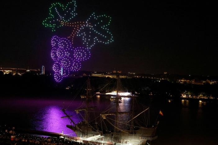 An aerial drone display by approximately 500 drones hovers over the Garonne River in Bordeaux, France on June 23, 2023. Some U.S. cities are planning their own drone shows as an alternative to Fourth of July fireworks.