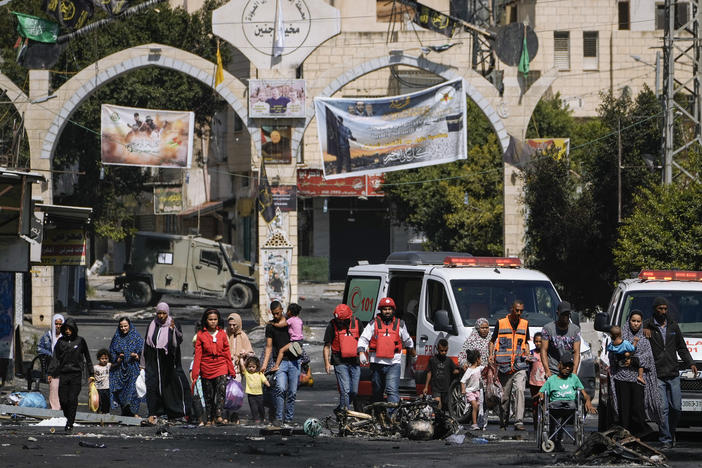 Residents of the Jenin refugee camp fled their homes as the Israeli military pressed ahead with an operation in the area, in Jenin, West Bank, Tuesday. Palestinian health officials put the Palestinian death toll from the two-day raid at 10. The Israeli military said Israel launched the operation because some 50 attacks over the past year had emanated from Jenin.