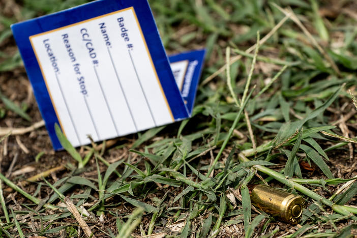 A bullet casing is seen at the site of a mass shooting in the Brooklyn Homes neighborhood in Baltimore, Maryland, on Sunday. Two people were killed and 28 others were wounded during the shooting at a block party on Saturday night.