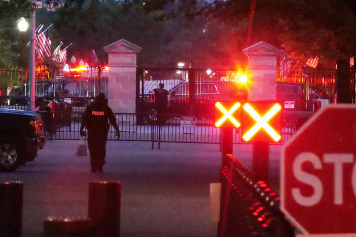 Police are seen outside the White House grounds, Sunday night, July 2, 2023 in Washington.