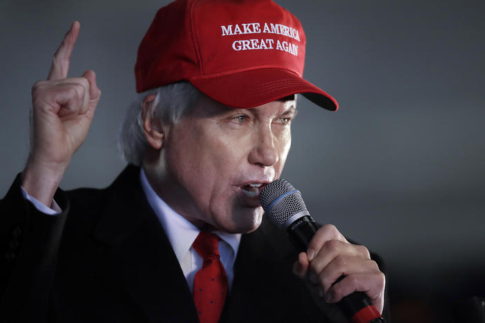 In this Dec. 2, 2020 file photo, attorney Lin Wood gestures while speaking during a rally in Alpharetta, Ga. Wood has asked officials in his home state of Georgia to retire his law license.