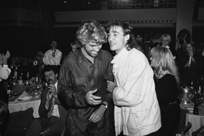 English singer-songwriters George Michael (1963 - 2016) and Andrew Ridgeley of pop duo Wham! at the Ivor Novello Awards, UK, 14th March 1985.