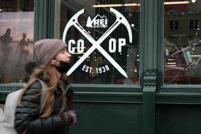 A pedestrian walks by REI's flagship store in New York, where last year workers formed the company's first union.