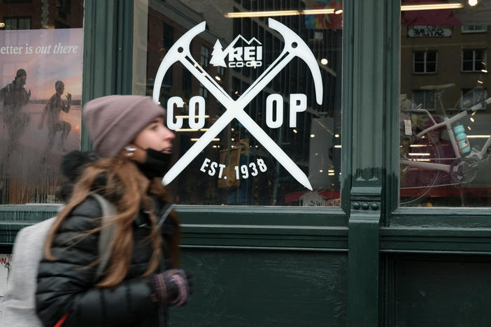 A pedestrian walks by REI's flagship store in New York, where last year workers formed the company's first union.