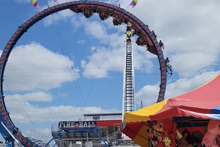 Videos posted to social media showed ride operators desperately trying to free the stuck Fireball Roller Coaster Sunday in Crandon, Wis.