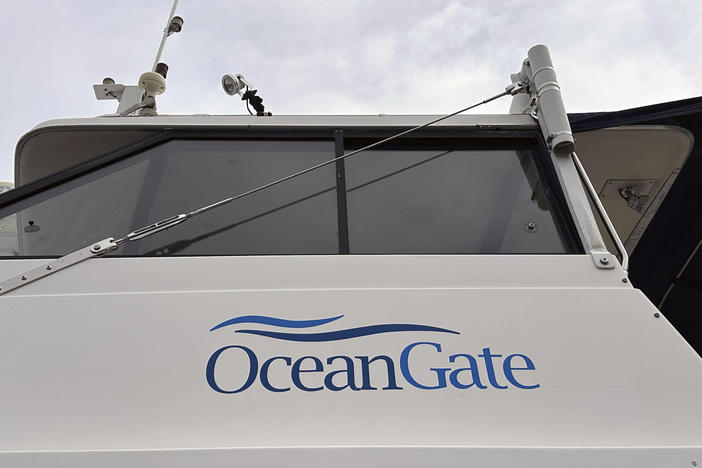 OceanGate says it's pausing its commercial and exploration operations. Its CEO, Stockton Rush, was among the five people killed when the company's Titan submersible imploded in June. Here, the OceanGate logo is seen on a boat parked near the company's offices in Everett, Washington.