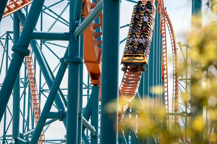 Visitors ride the roller coaster Scream at the Six Flags Magic Mountain theme park in Valencia, Calif., in 2021.