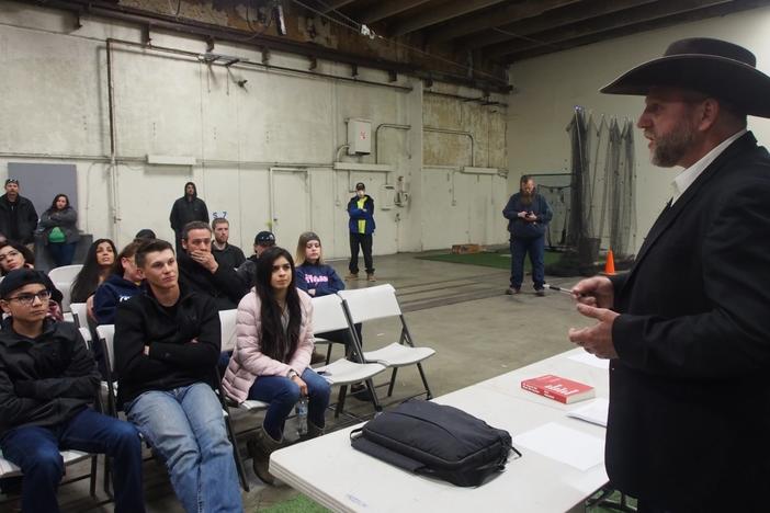 Ammon Bundy speaks to a crowd of supporters in 2020 during the COVID-19 lockdown.