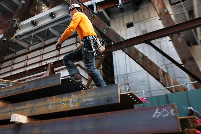 Construction workers prepare steel for a crane at construction site in New York City on May 18, 2023.