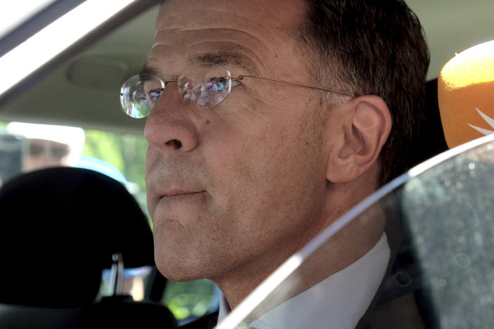 Dutch Prime Minister Mark Rutte sits in a car as he leaves Palace Huis ten Bosch in The Hague, Netherlands, Saturday, July 8, 2023 after he informed King Willem-Alexander that his coalition government has resigned.