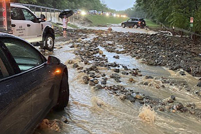 Vehicles come to a standstill near a washed-out and flooded portion of the Palisades Parkway just beyond the traffic circle off the Bear Mountain Bridge, Sunday, July 9, 2023, in Orange County, N.Y.