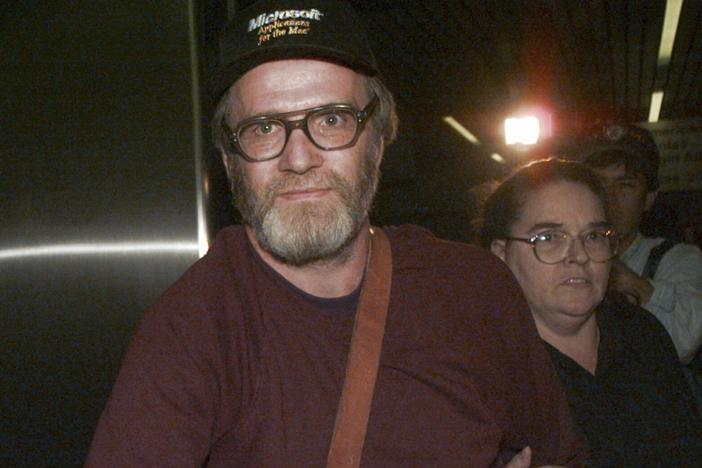 James Lewis is shown being escorted through Boston's Logan Airport, Friday Oct. 13, 1995, after being released from the Federal Correctional Institution in Oklahoma.