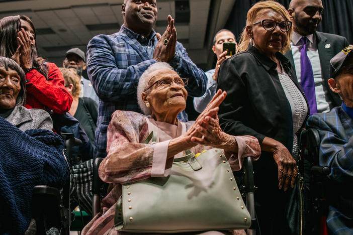 (L-R) Survivors Lessie Benningfield Randle, Viola Fletcher, and Hughes Van Ellis sing together at the conclusion of a rally during commemorations of the 100th anniversary of the Tulsa Race Massacre in 2021.