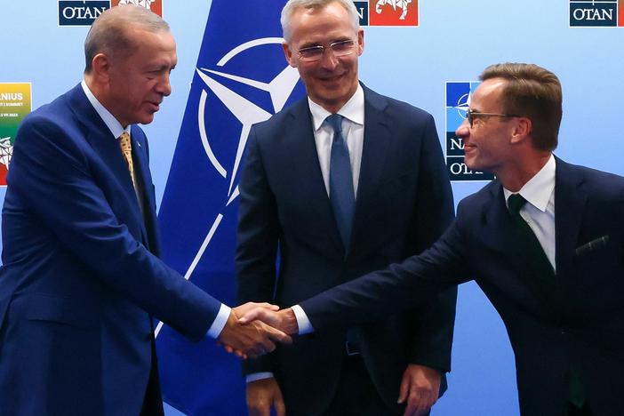 Turkish President Tayyip Erdogan (left) and Swedish Prime Minister Ulf Kristersson shake hands in front of NATO Secretary-General Jens Stoltenberg prior to their meeting, on the eve of a NATO summit, in Vilnius, Lithuania, on Monday.