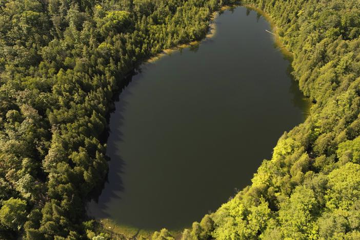 Trees surround Crawford Lake in Milton, Ontario., on Monday, July 10, 2023. A team of scientists is recommending the start of a new geological epoch defined by how humans have impacted the Earth should be marked at the pristine Crawford Lake outside Toronto in Canada.
