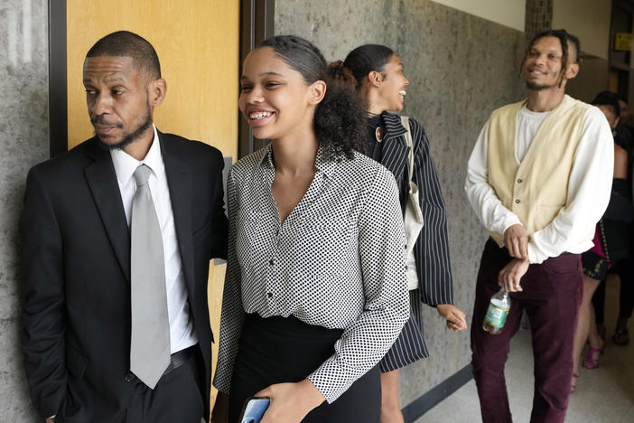 Kecalf Franklin, a son of music superstar Aretha Franklin leaves a court hearing with his family on Tuesday in Pontiac, Mich. A document handwritten by singer Aretha Franklin and found in her couch after her 2018 death is a valid Michigan will, a jury said Tuesday, a critical turn in a dispute that has turned her sons against each other.