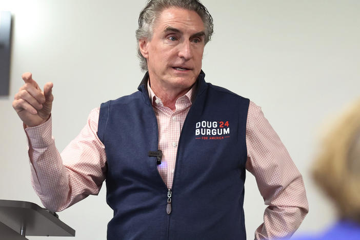 Republican presidential contender Doug Burgum, who's governor of North Dakota, is offering to send people $20 gift cards if they donate as little as $1 to his campaign. He's seen here last month speaking in Ankeny, Iowa.