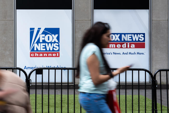 A man who was at the Jan. 6 attack on the U.S. Capitol has sued Fox News for defamation. Here, a woman walks by the Fox News headquarters in New York in April.
