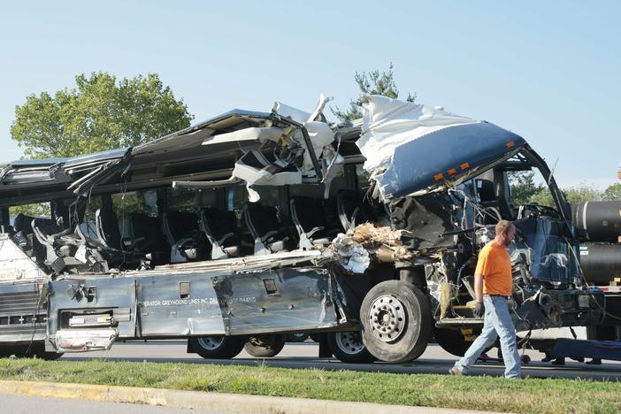 A Greyhound bus is pictured after it crashed into three commercial vehicles parked on a highway exit ramp in Highland, Ill., early Wednesday morning. The collision killed three people and injured at least 14 others.