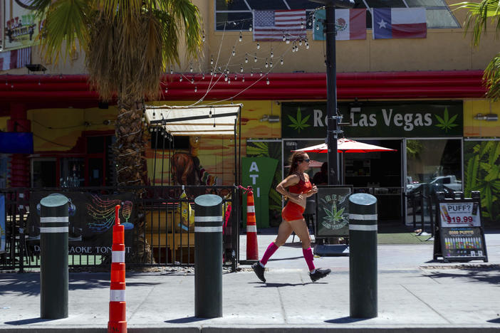 A person jogs on the Las Vegas Strip during a heat advisory on Friday.