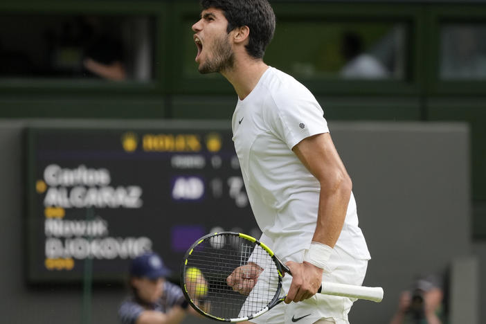 Spain's Carlos Alcaraz celebrates after winning a point against Serbia's Novak Djokovic in the final of the men's singles on day fourteen of the Wimbledon tennis championships in London on Sunday.