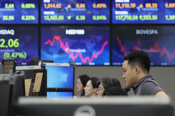 A currency trader watches monitors at the foreign exchange dealing room of the KEB Hana Bank headquarters in Seoul, South Korea, Monday, July 17, 2023. Asian shares were mostly lower on Monday after China reported weaker growth than forecast in the last quarter.
