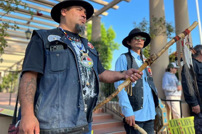 Josh Dini and Gary McKinney protest a planned lithium mine outside a federal appeals court in California in June.