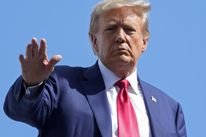 Former President Donald Trump waves before boarding his personal plane at Miami International Airport on June 13, in Miami after his first court appearance in the classified documents case.