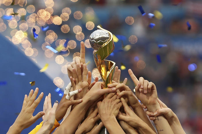 In this photo from July 7, 2019, U.S. players hold the trophy as they celebrate winning the Women's World Cup final soccer match against The Netherlands at the Stade de Lyon in Decines, outside Lyon, France. The 2023 Women's World Cup will be spread across nine cities in Australia and New Zealand.