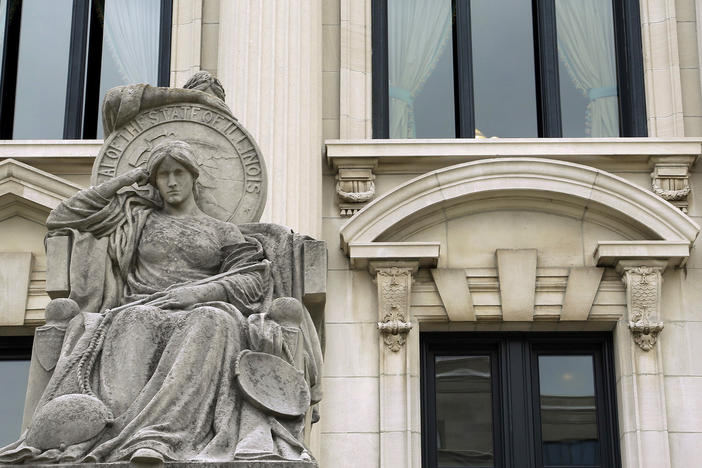 The Illinois Supreme Court on Tuesday upheld the constitutionality of a state law ending cash bail, ordering implementation in mid-September. Here, in this August 2014 photo shows a statue outside of the Illinois Supreme Court building in Springfield, Ill.