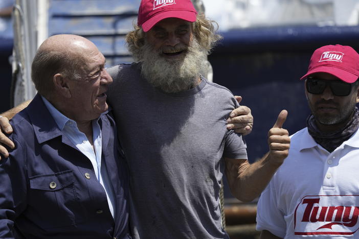 Australian Timothy Lyndsay Shaddock gives a thumbs up during a welcoming ceremony with Grupo Mar President Antonio Suarez, left, and Oscar Meza Oregó, captain of the Mexican tuna boat "Maria Delia," after being rescued from sea and arriving to port in Manzanillo, Mexico, Tuesday, July 18, 2023.