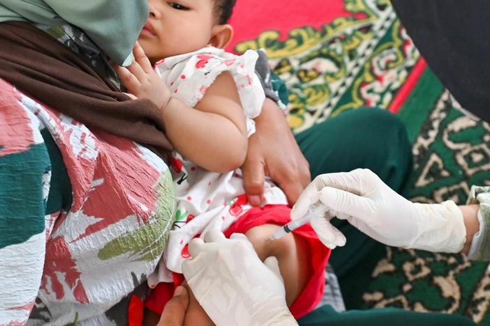 A baby receives the DPT vaccine, that can prevent diphtheria, pertussis, and tetanus, as part of a monthly check-up medical program for children at an integrated services post in Banda Aceh on June 8, 2023.