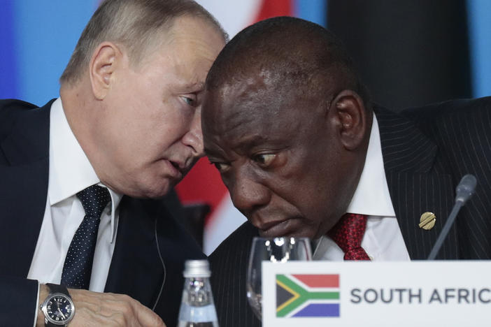 Russian President Vladimir Putin (left) speaks to South African President Cyril Ramaphosa during a plenary session at the Russia-Africa summit in the Black Sea resort of Sochi, Russia, on Oct. 24, 2019.