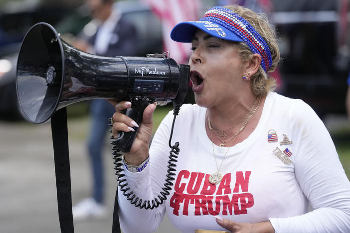A supporter of former President Donald Trump speaks into a megaphone as supporters gather in Tropical Park in Miami, to convoy to his Mar-A-Lago club in Palm Beach, Fla., June 11.