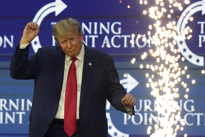 Former President Donald Trump dances on stage at the Turning Point Action conference on July 15.