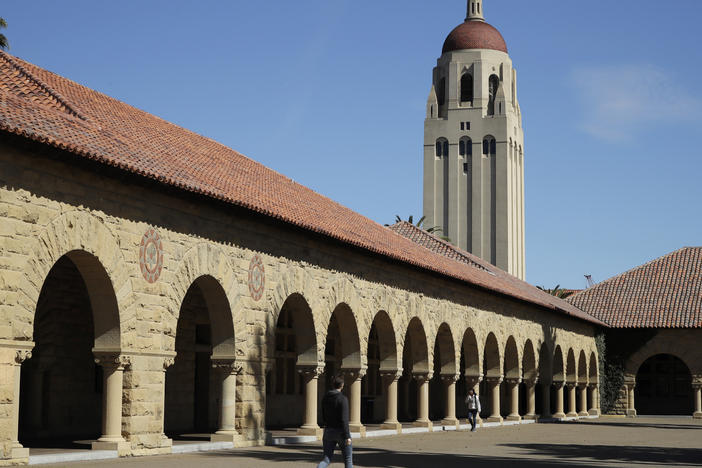 People walk on the Stanford University campus beneath Hoover Tower in Stanford, Calif., on March 14, 2019. Stanford President Marc Tessier-Lavigne said on Wednesday he would resign, citing an independent review that cleared him of research misconduct but found flaws in other papers authored by his lab.