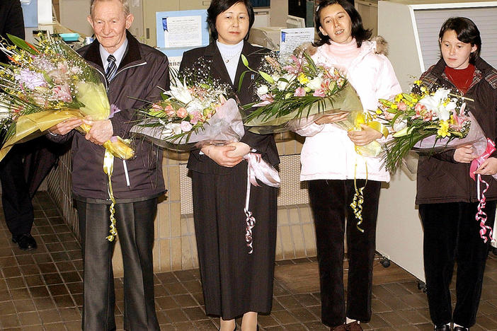 Charles Jenkins (left), age 64, his wife Hitomi Soga (second from left) and their daughters arrive at Japan's Sado Island in December 2004, almost 40 years after he defected to North Korea.