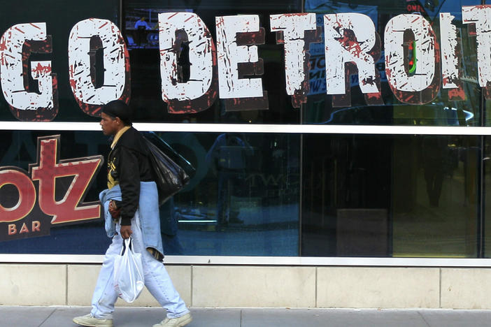 In this Oct. 24, 2012 file photo, a pedestrian walks in Greektown in downtown Detroit. A state-appointed review team Tuesday, Feb. 19, 2013 determined Detroit is in a financial emergency, paving the way for Republican Gov. Rick Snyder to appoint an emergency manager who would need to come up with a new plan to get the city out of its fiscal crisis.