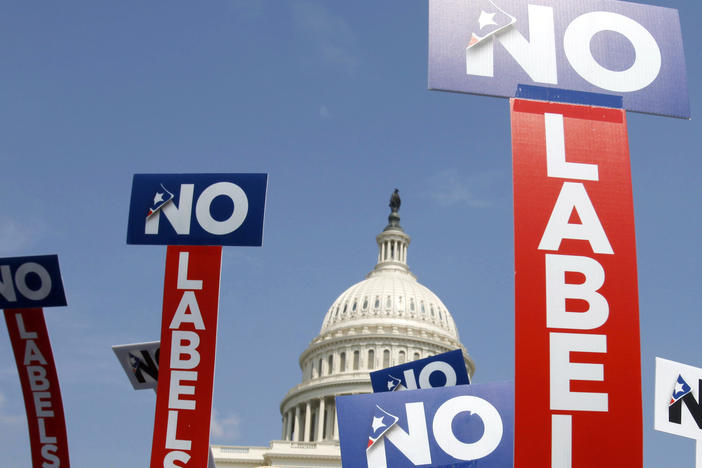 People with the group No Labels hold signs during a rally on Capitol Hill in Washington, D.C., on July 18, 2011.