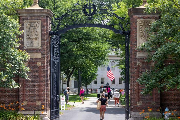CAMBRIDGE, MASSACHUSETTS - JUNE 29: People walk through the gate on Harvard Yard at the Harvard University campus on June 29, 2023 in Cambridge, Massachusetts.